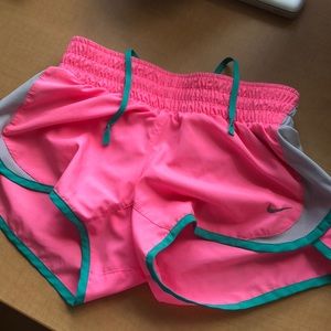 Neon pink and with blue trim nike short-shorts.